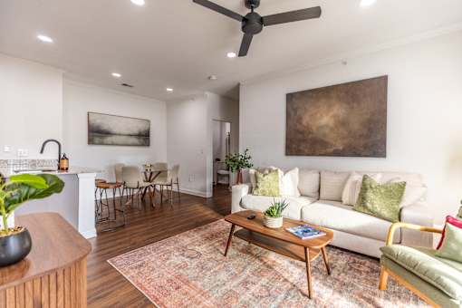 A living room with a couch, chairs, and a coffee table.