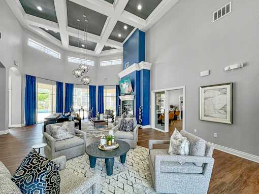 a living room with blue curtains and a white coffered ceiling at 92West, West Des Moines Iowa  