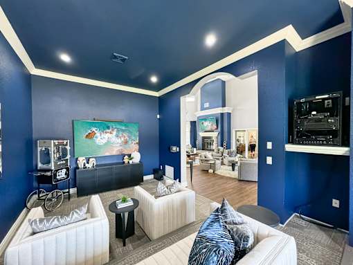 a living room with blue walls and white furniture at 92West, Iowa  