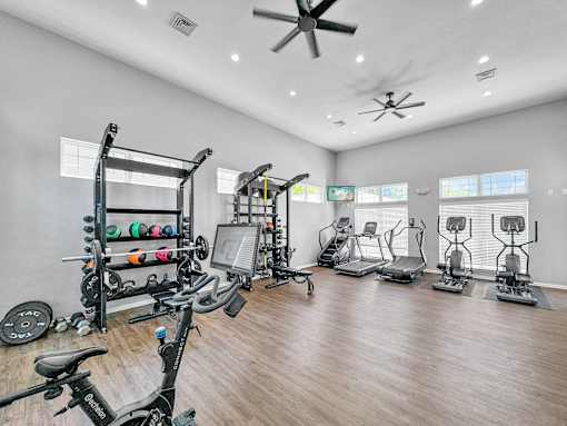 a home gym with exercise machines and a ceiling fan at 92West, Iowa  