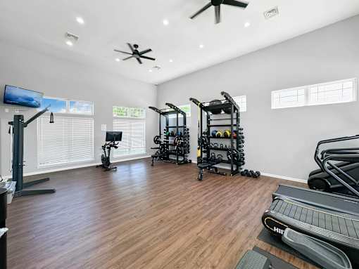 the gym has plenty of exercise equipment and windows at 92West, West Des Moines, 50266  
