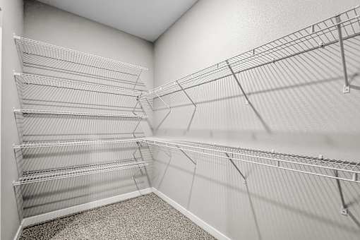 Empty shelves in a room with a carpeted floor.