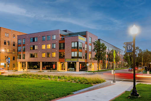 a city street with a building with a street light at Canary Lofts, Des Moines, IA