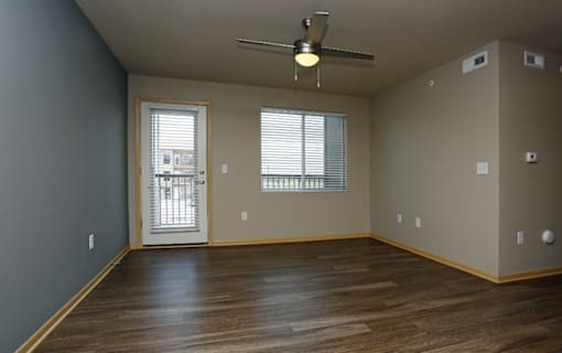 Living room with a ceiling fan and wooden flooring at Cedarbrooke Place , Norwalk, 50211