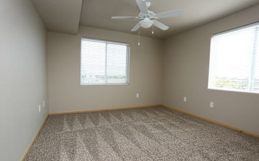 Carpeting In Bedrooms with a ceiling fan at Cedarbrooke Place , Norwalk, Iowa