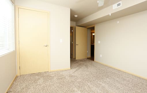 Bedroom with a tan carpet and closet at Cedarbrooke Place , Iowa , 50211