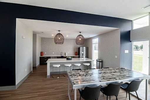a dining room and kitchen with a marble table and chairs at Centennial Crossing, Iowa, 50263