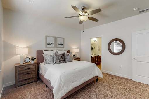 a bedroom with a bed and a ceiling fan at Centennial Crossing, Iowa, 50263