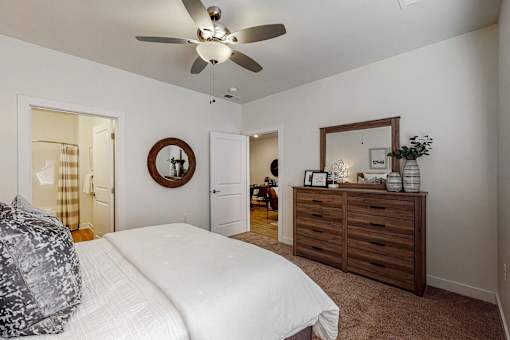 a bedroom with a bed and a ceiling fan at Centennial Crossing, Waukee
