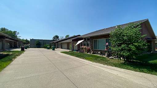A long driveway leads to a row of houses.at Cottages at Johnston Commons, Johnston  