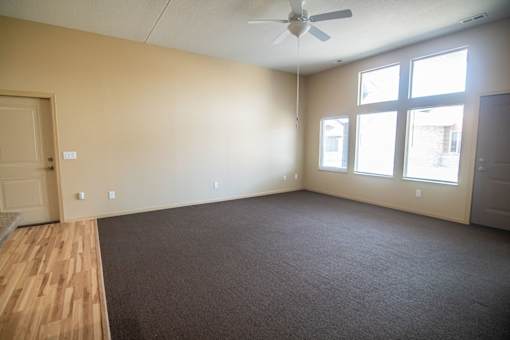Empty room with a ceiling fan and three windows.at Cottages at Johnston Commons, Johnston, 50131  