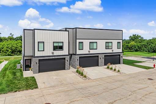 A modern two-story house with a garage on the ground floor.