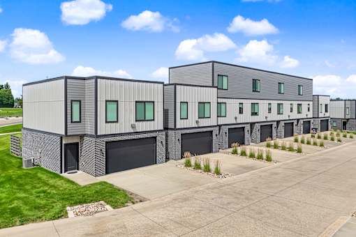 A row of modern buildings with garage doors.