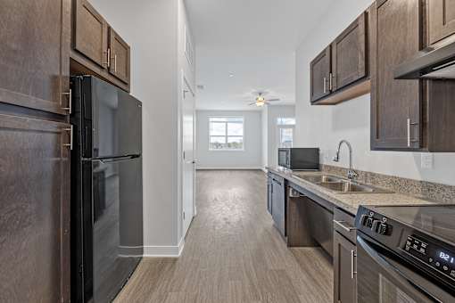 A kitchen with dark wood cabinets and stainless steel appliances.