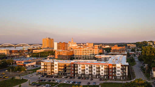 A modern building with a parking lot in front of it.