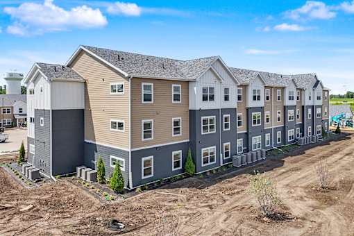 A row of new houses are being built in a residential area.