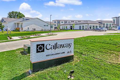 A sign for Callaway stands in front of a building.