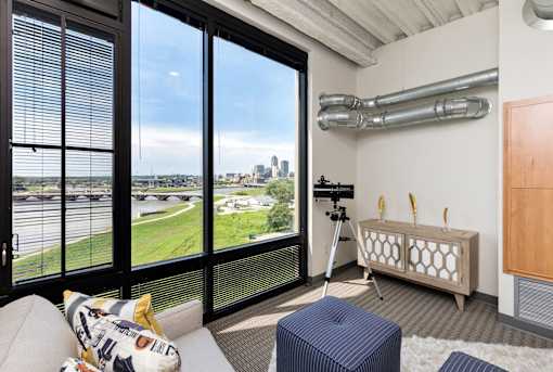 A room with a large window overlooking a cityscape. at Eagle View Lofts, Iowa, 50309