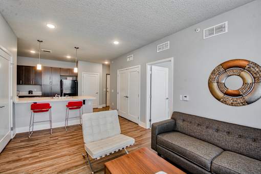 A living room with a grey couch and a white chair.