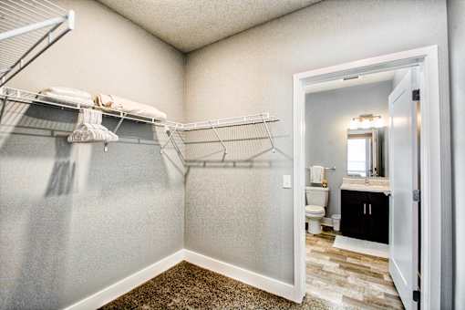 A bathroom with a towel rack and a mirror.