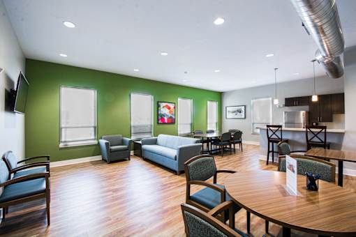 A room with a green wall and a wooden floor.