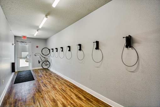 A hallway with a bicycle and a door with an exit sign.
