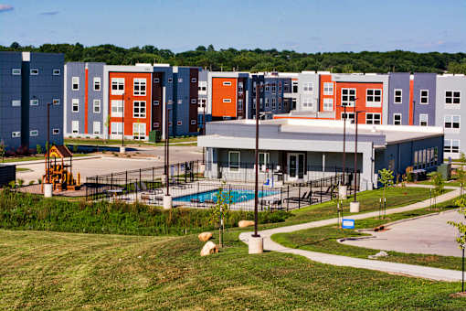 A large building with a pool in front of it.