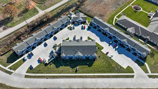 A large building with a parking lot in front of it.