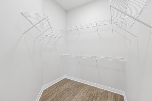 Empty room with white walls and wooden floor.