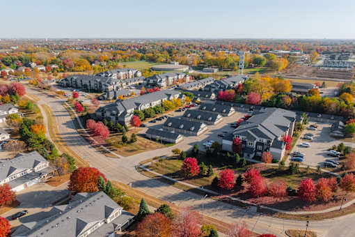 A suburban neighborhood with houses and trees in autumn colors. at Stonegate Crossing Apartments, Clive, IA, 50325