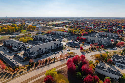A view of a residential area with houses and trees. at Stonegate Crossing Apartments, IOWA, 50325