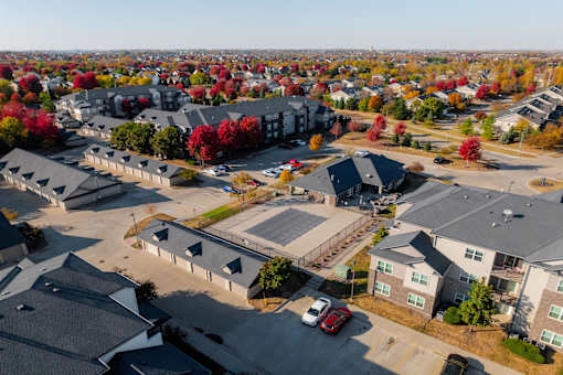 A bird's eye view of a residential area with houses and cars. at Stonegate Crossing Apartments, Clive, 50325