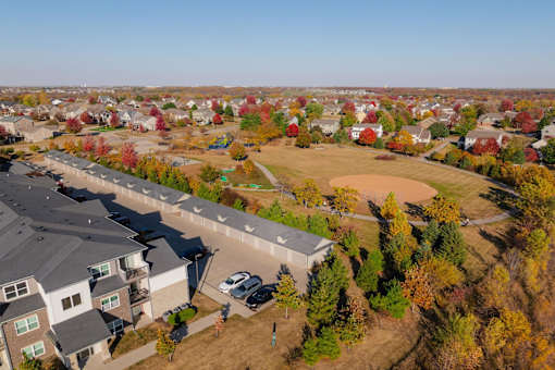 A suburban neighborhood with houses and trees in autumn colors. at Stonegate Crossing Apartments, Clive, IA