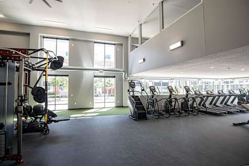 A gym with a row of treadmills and a weight rack.at Linc, Iowa, 50309
