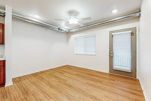 A room with wooden flooring and a ceiling fan at Melbourne Apartments, Iowa, 50320