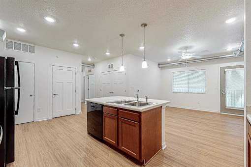 A kitchen with a sink and a refrigerator at Melbourne Apartments, Iowa, 50320