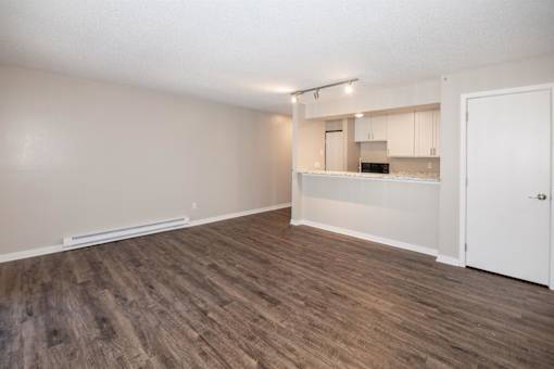 A room with a kitchenette and a door. at Rosemont Place Apartments, Des Moines