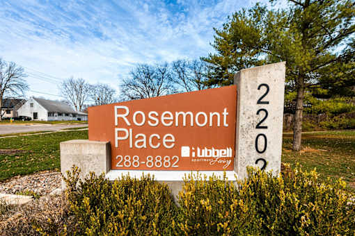 A sign for Rosemont Place with a phone number and a logo at Rosemont Place Apartments, Des Moines, IA