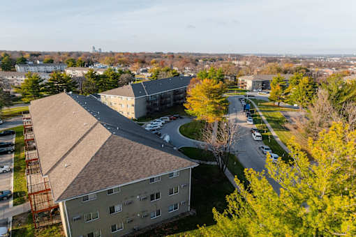 A view of a building with a parking lot in front of it. at Rosemont Place Apartments, Des Moines, 50320