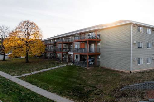 Apartment building with a tree in front of it. at Rosemont Place Apartments, Des Moines, IA, 50320
