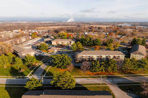 A view of a school from above with a road running through it. at Rosemont Place Apartments, Des Moines, Iowa