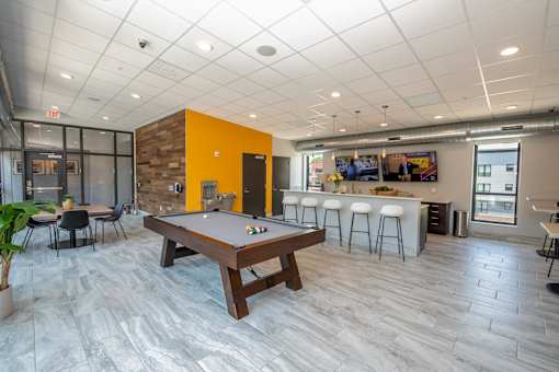 a game room with a pool table and a bar at Soll, Des Moines Iowa   