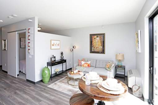 a living room with a couch and a table at Soll, Des Moines  