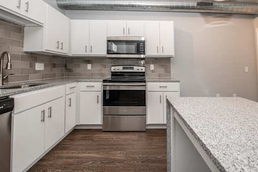 a kitchen with white cabinets and stainless steel appliances at Soll, Iowa, 50312