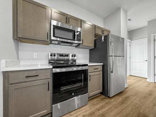 a kitchen with stainless steel appliances and a refrigerator at Soll, Des Moines, 50312  