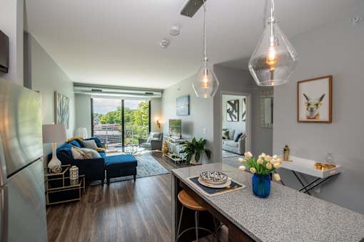 a living room with a kitchen and a dining table at Soll, Des Moines, IA  
