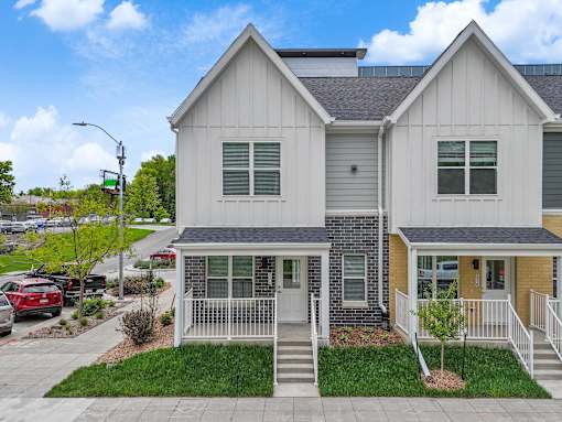 an exterior view of a house with a yard and a sidewalk at Soll, Des Moines  