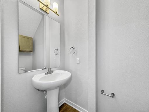 a white bathroom with a sink and a mirror at Soll, Des Moines, 50312  