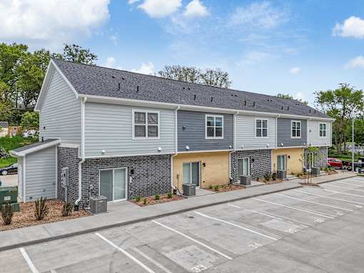 a gray and yellow building with a parking lot at Soll, Iowa   