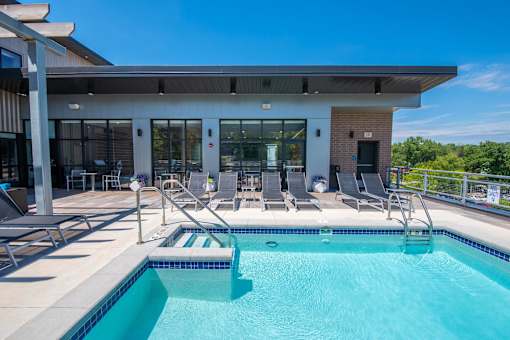the pool and patio area of a building with a swimming pool at Soll, Des Moines, IA  